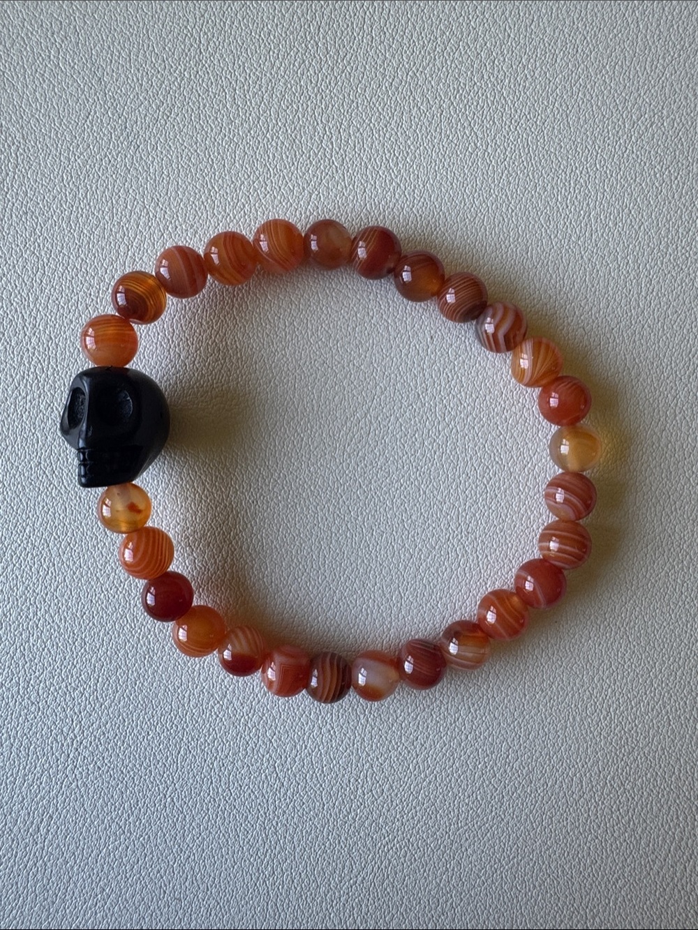 Carnelian Bead Bracelet with Black Skull Accent